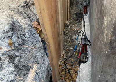 Foundation repair lifting sunken concrete slab with hydraulic piers